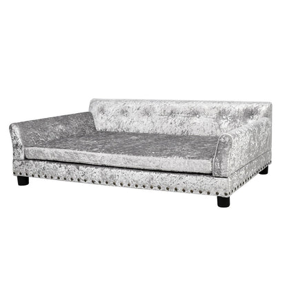 Lit pour animaux de compagnie en forme de canapé en velours capitonné, recouvert de tissu et doté d'un coussin amovible.