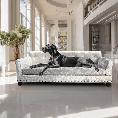 Lit pour animaux de compagnie en forme de canapé en velours capitonné, recouvert de tissu et doté d'un coussin amovible.
