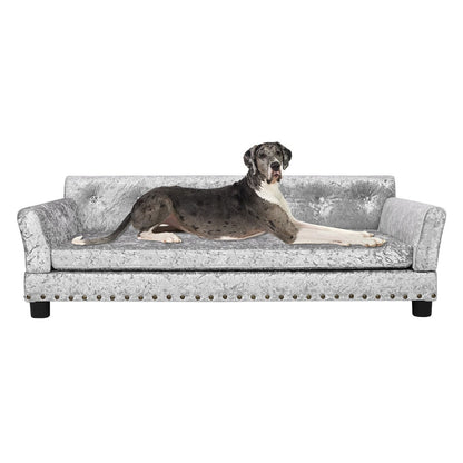 Lit pour animaux de compagnie en forme de canapé en velours capitonné, recouvert de tissu et doté d'un coussin amovible.