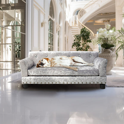 Lit pour animaux de compagnie en forme de canapé en velours capitonné, recouvert de tissu et doté d'un coussin amovible.