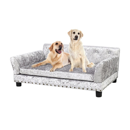Lit pour animaux de compagnie en forme de canapé en velours capitonné, recouvert de tissu et doté d'un coussin amovible.